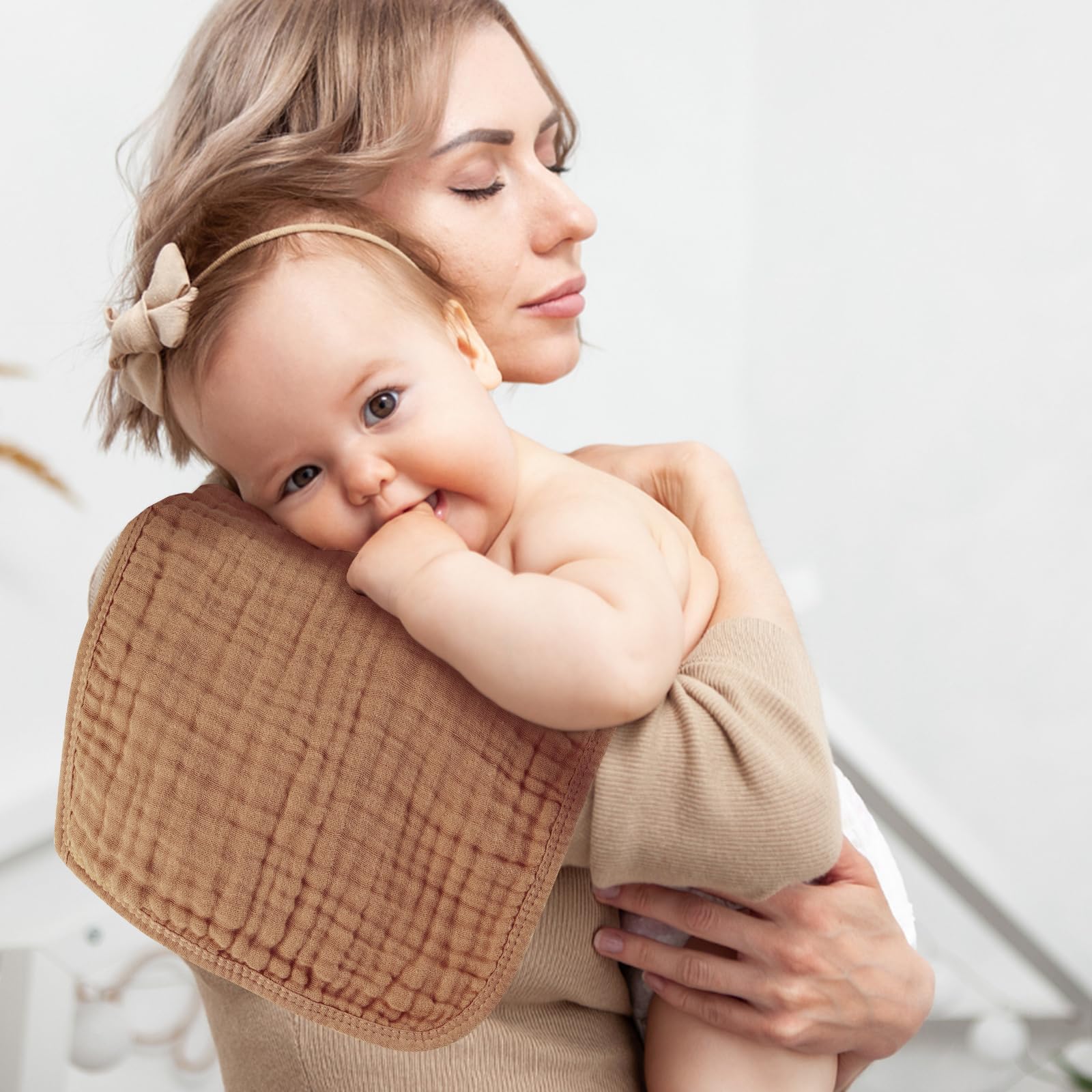 MIGIOL natural cotton burp cloth being used as a gentle face wipe for sensitive baby skin