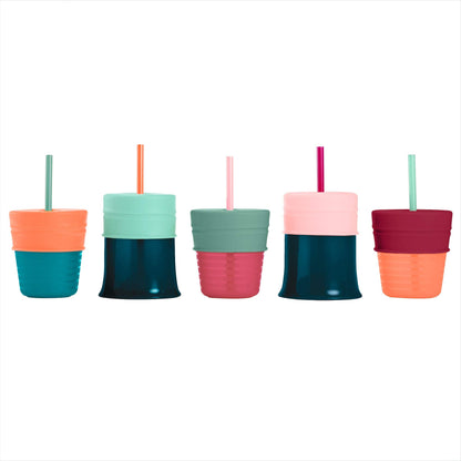 Boon Snug travel essential spill proof sippy cup lids set being stretched over a kitchen glass cup demonstrating flexibility