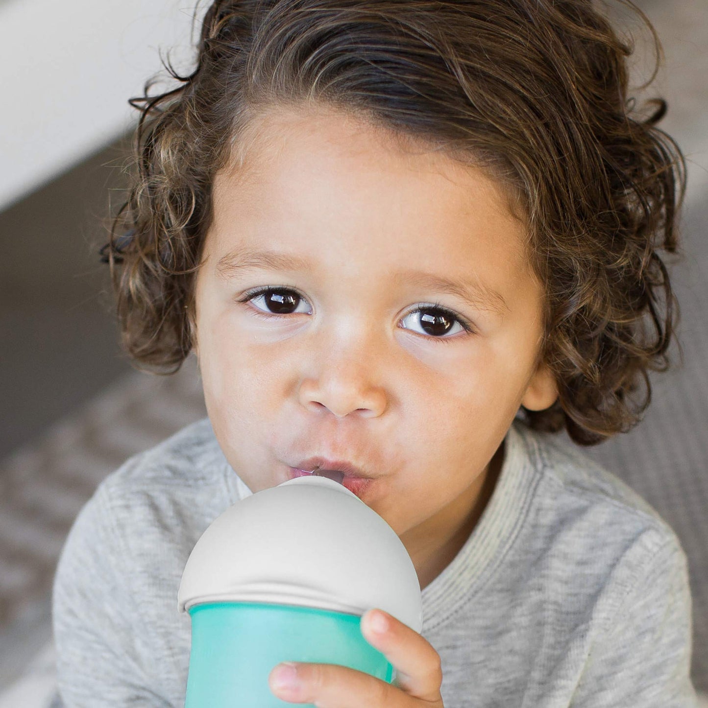 Boon Nursh transition sippy cup top attached to silicone baby bottle shell