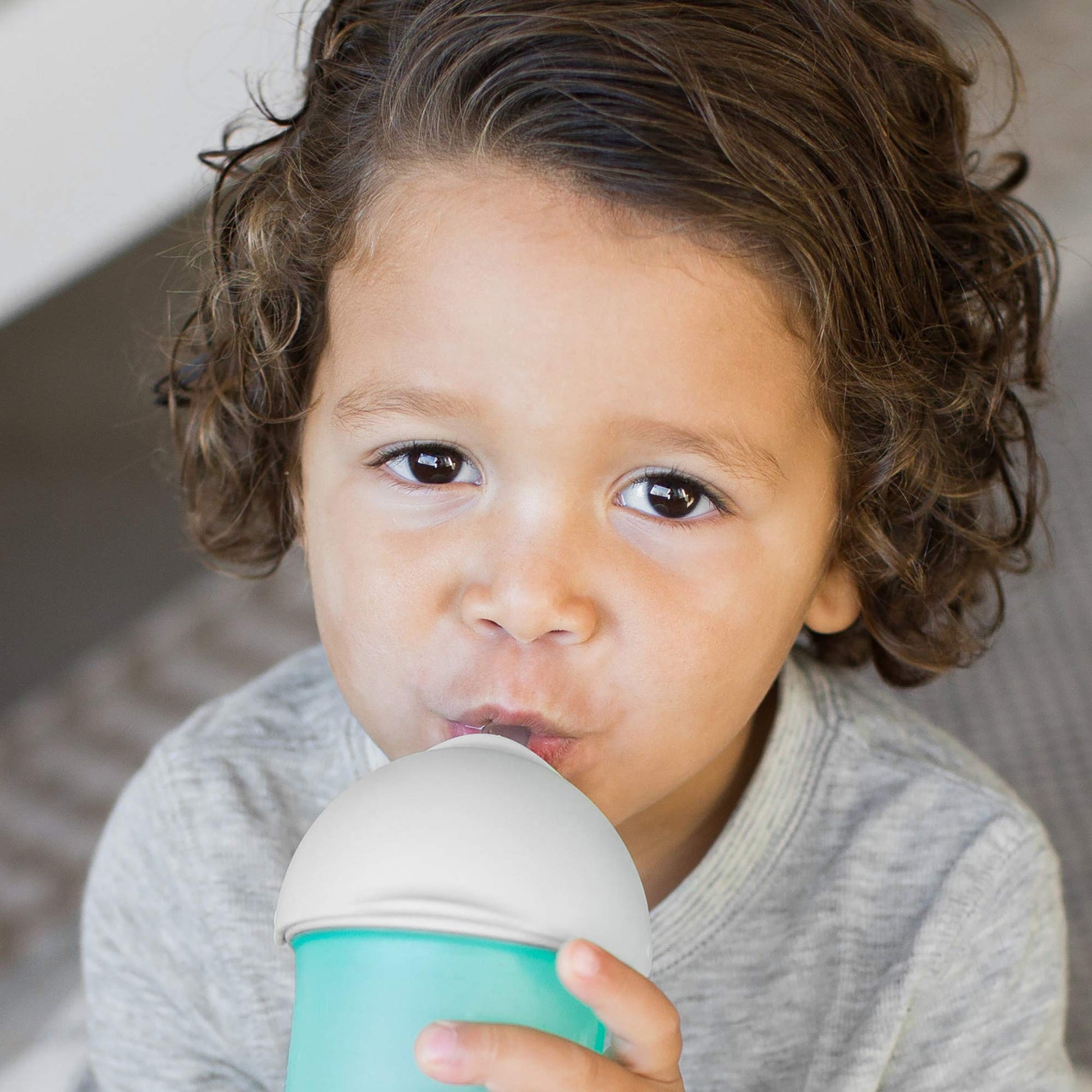 Boon Nursh transition sippy cup top attached to silicone baby bottle shell