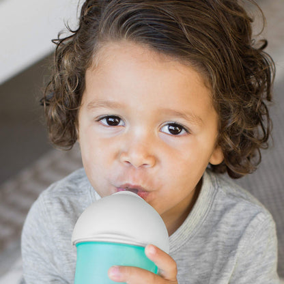 Boon Nursh transition sippy cup top attached to silicone baby bottle shell