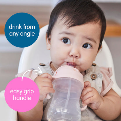 Ergonomic infant learning cup with travel friendly non spill pink cover.