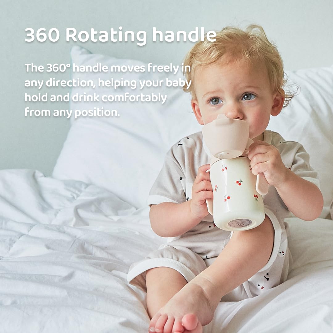 Toddler holding the Grosmimi insulated stainless steel cherry design cup