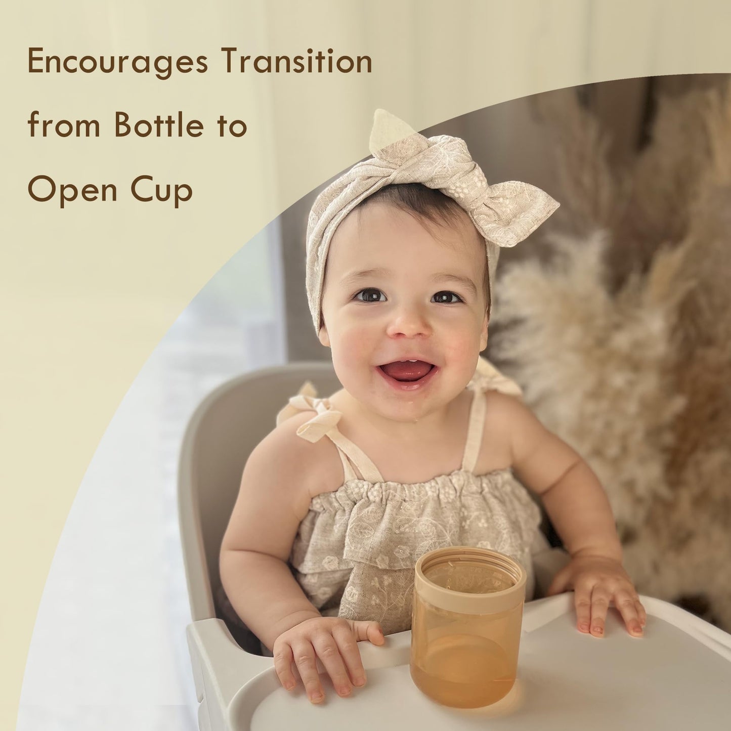 Child holding Moonkie silicone straw cup for easy grip