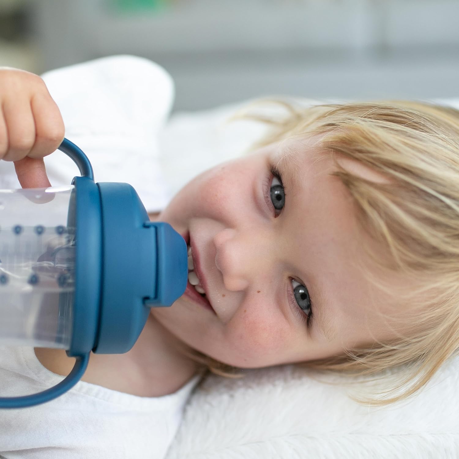 Infant training cup with flexible weighted silicone straw mechanism shown clearly.