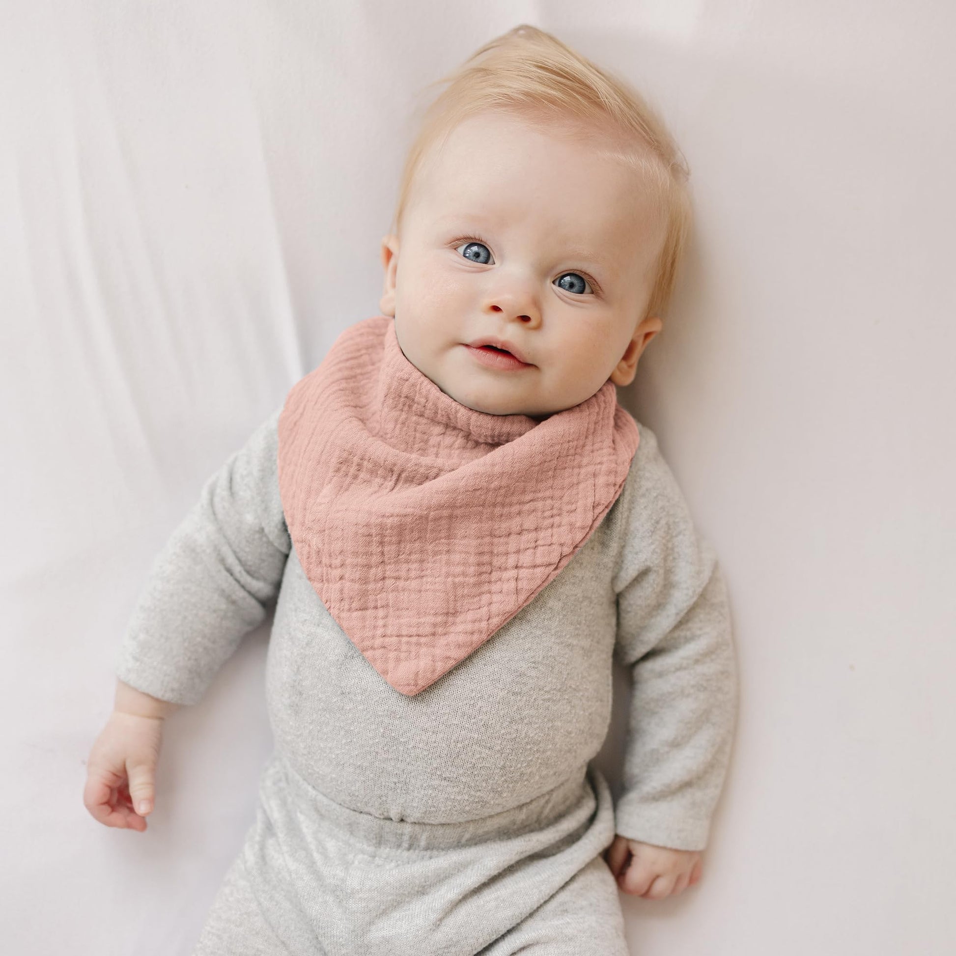 Konssy muslin drool bibs modeled on a baby