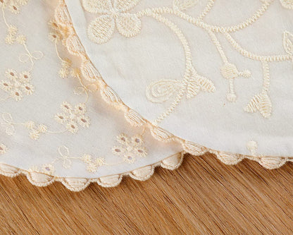 Handmade cotton bib with pom pom lace detail