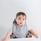 Five count pack of Green Sprouts organic muslin bibs