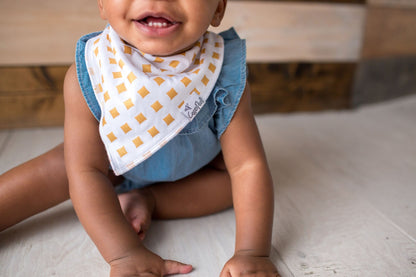 Baby wearing trendy Copper Pearl bandana style bib
