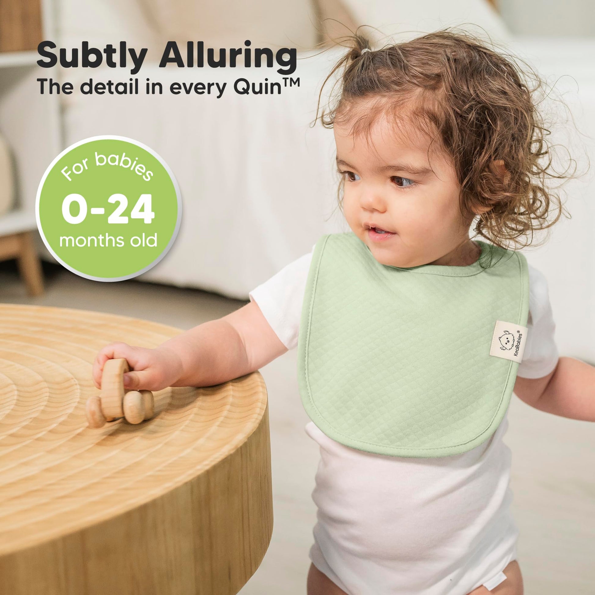 Model baby wearing KeaBabies muted pastel drool bib.