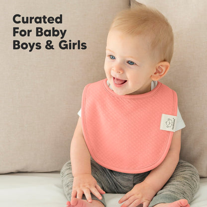 Full set of 8 KeaBabies organic cotton bibs neatly stacked.