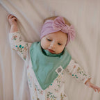Detailed view of Parker Baby Co. bibs showing nickel-free snap closures