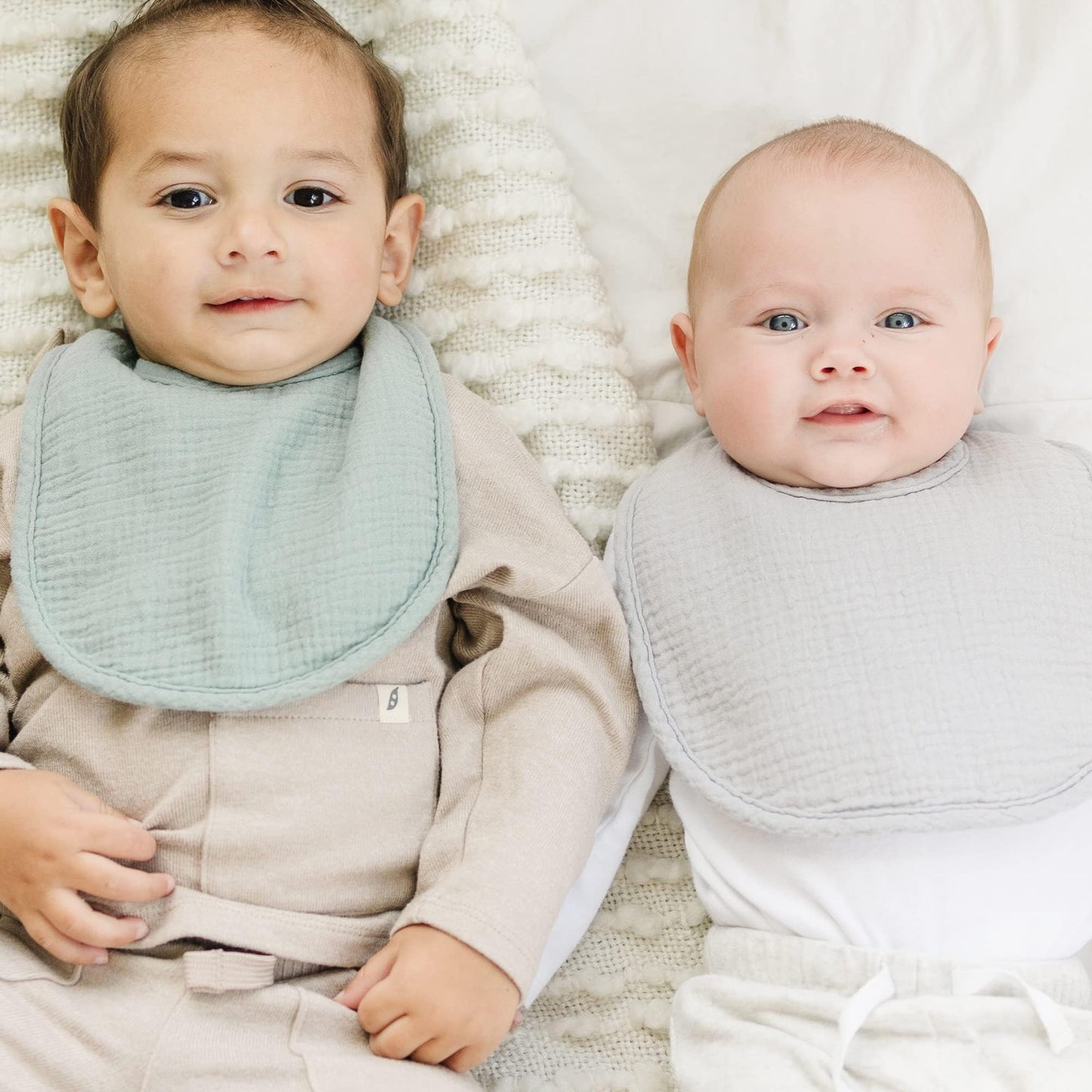 Baby wearing Konssy muslin bandana bib for teething.