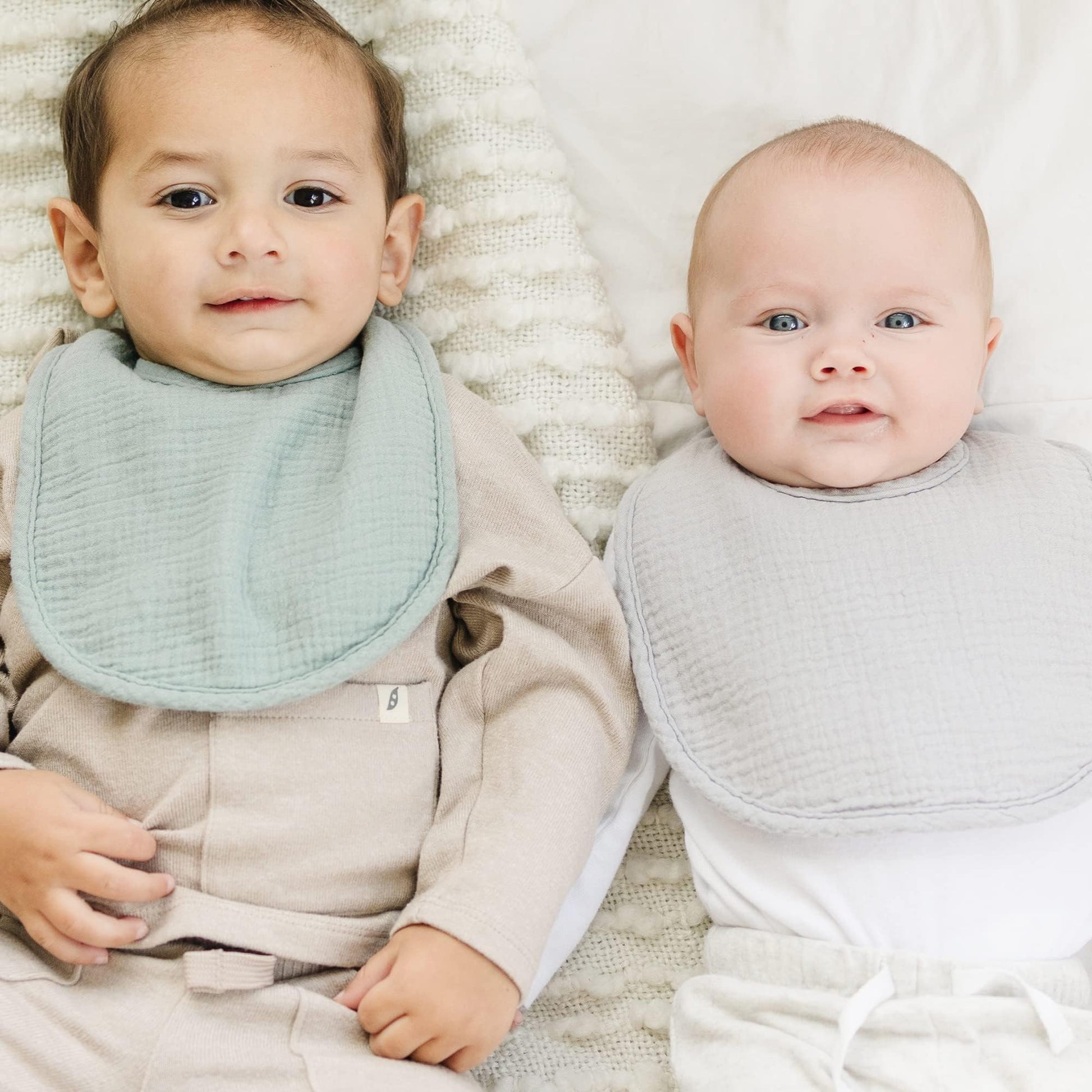 Baby wearing Konssy muslin bandana bib for teething.