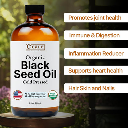 Side angle view of Vocks C Care eight ounce black seed oil highlighting the rich amber glass protection