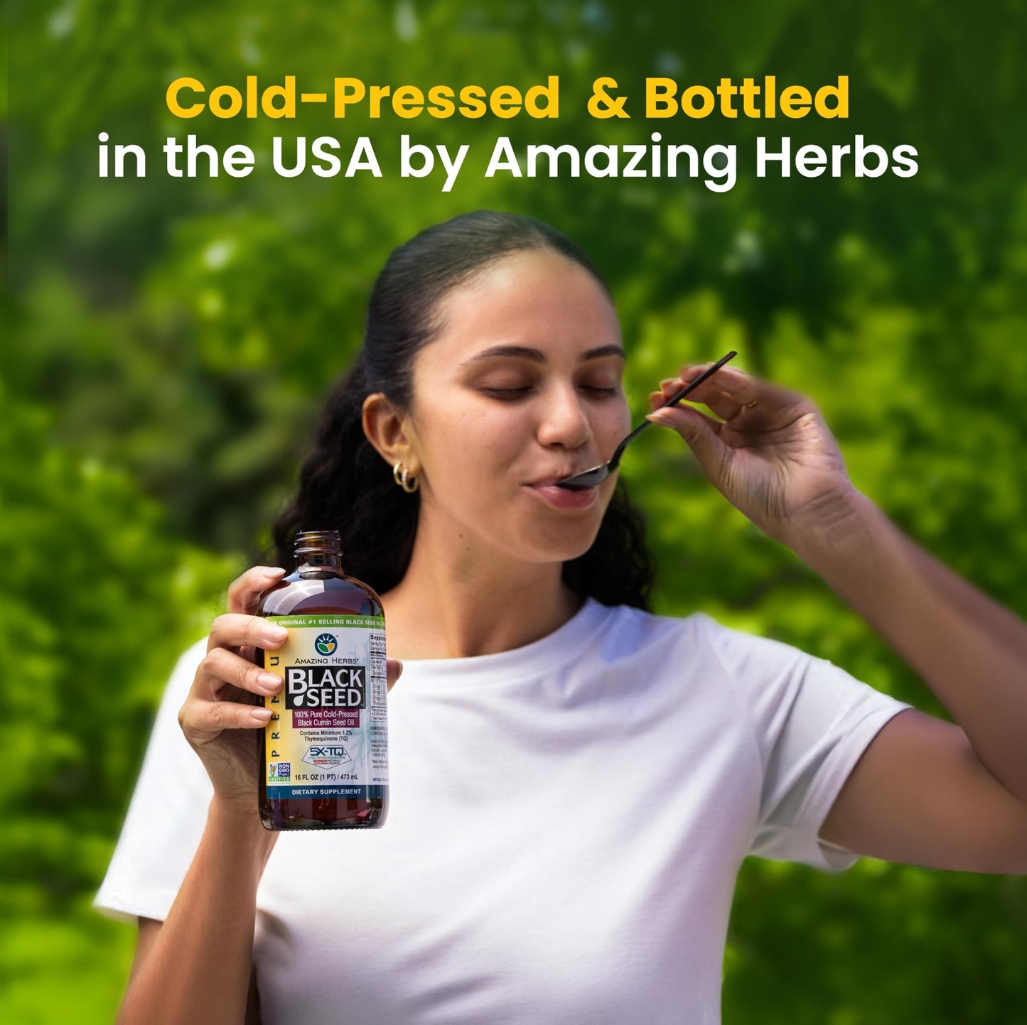 Cold pressed black seed oil liquid supplement poured into a teaspoon for daily dosage visualization