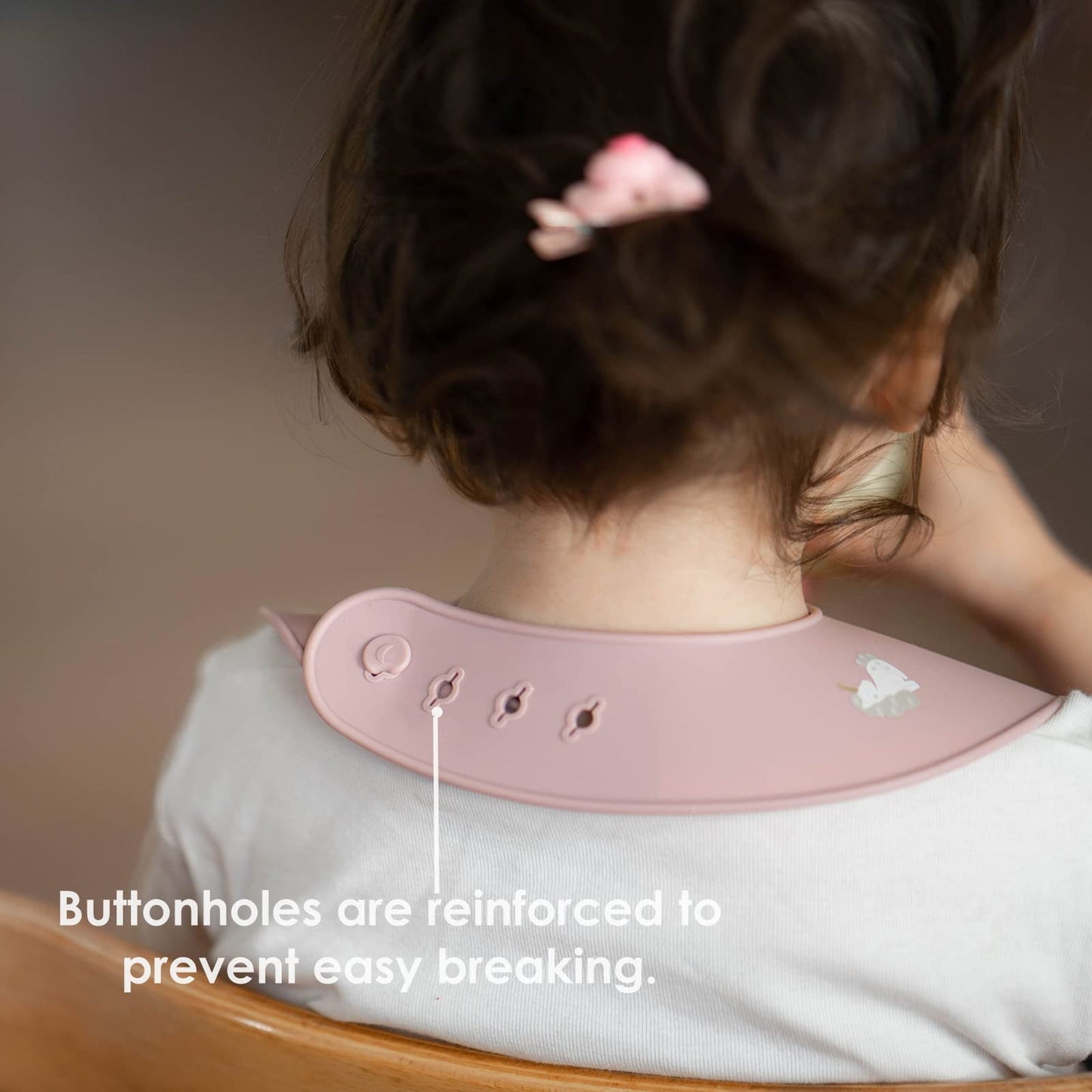 Adjustable neck closure buttonholes on ROCCED toddler feeding bib