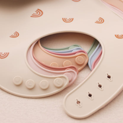 Two pieces of ROCCED adjustable waterproof baby bibs laid flat