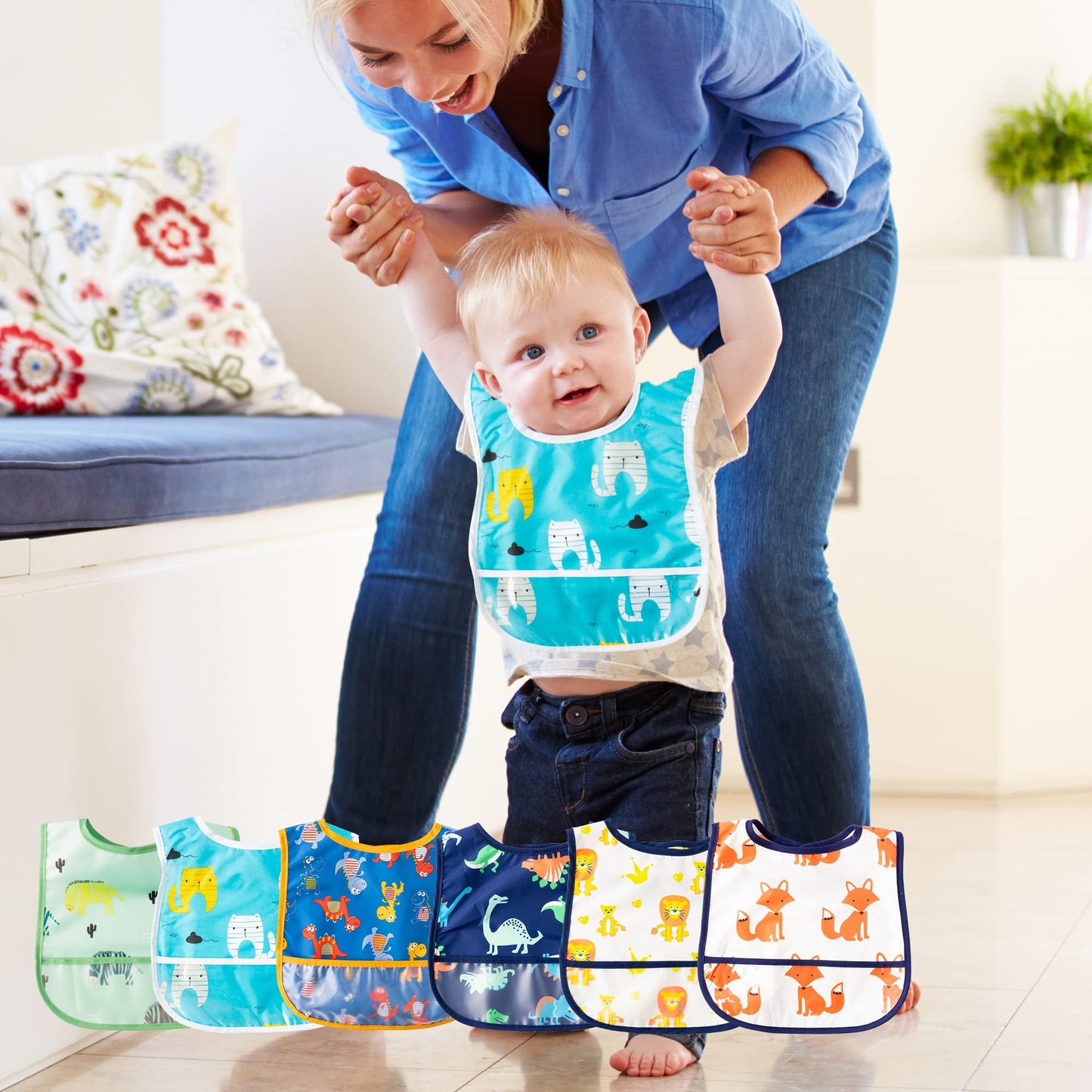 Mother wiping clean a 2ooya waterproof food bib with a damp cloth after an infant feeding session