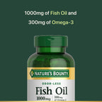Close-up view of Nature's Bounty coated fish oil softgels arranged next to the green supplement bottle.