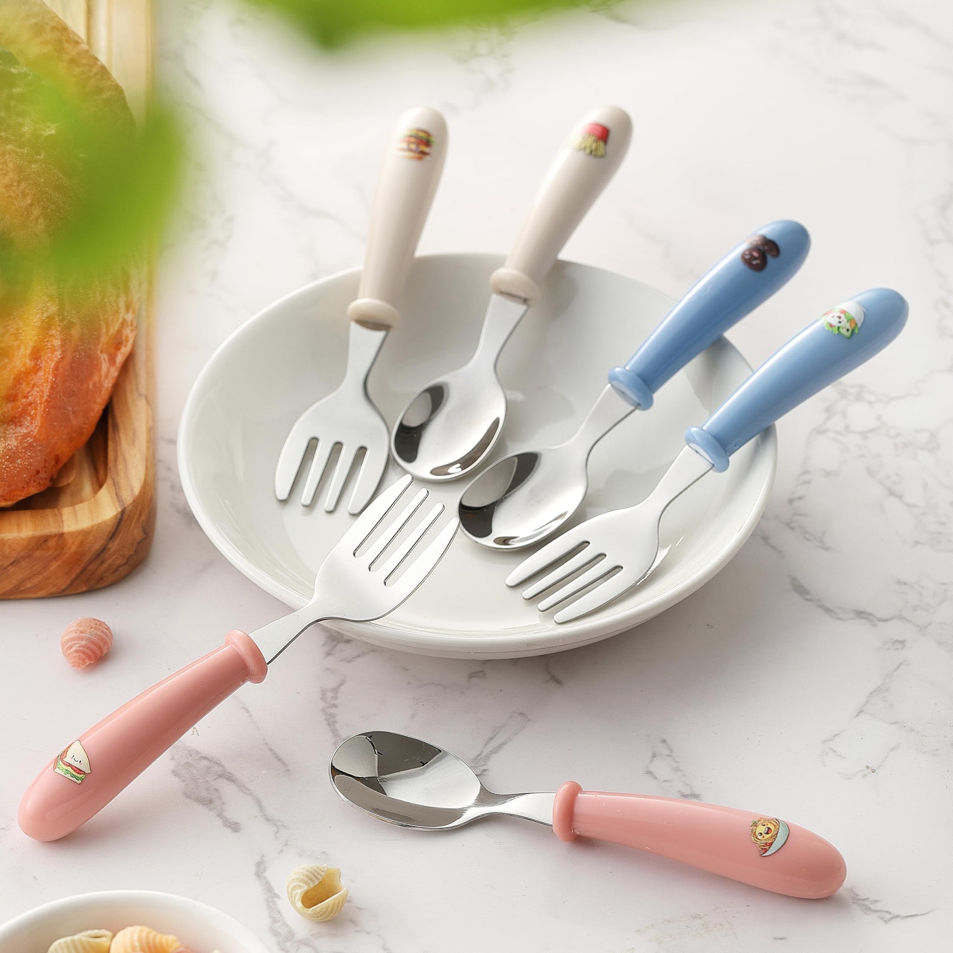 MONGSEW six piece kids spoon and fork set arranged neatly on a clean dining table background