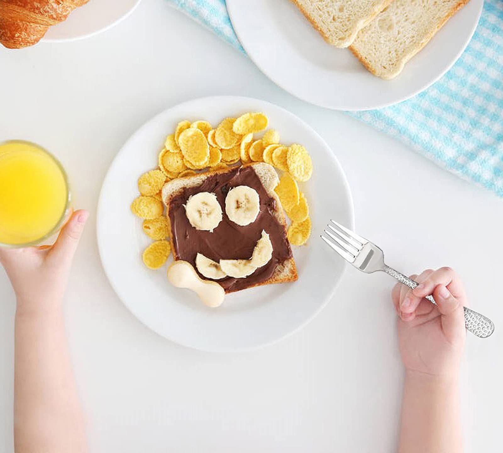 Toddler holding HaWare stainless steel fork at mealtime