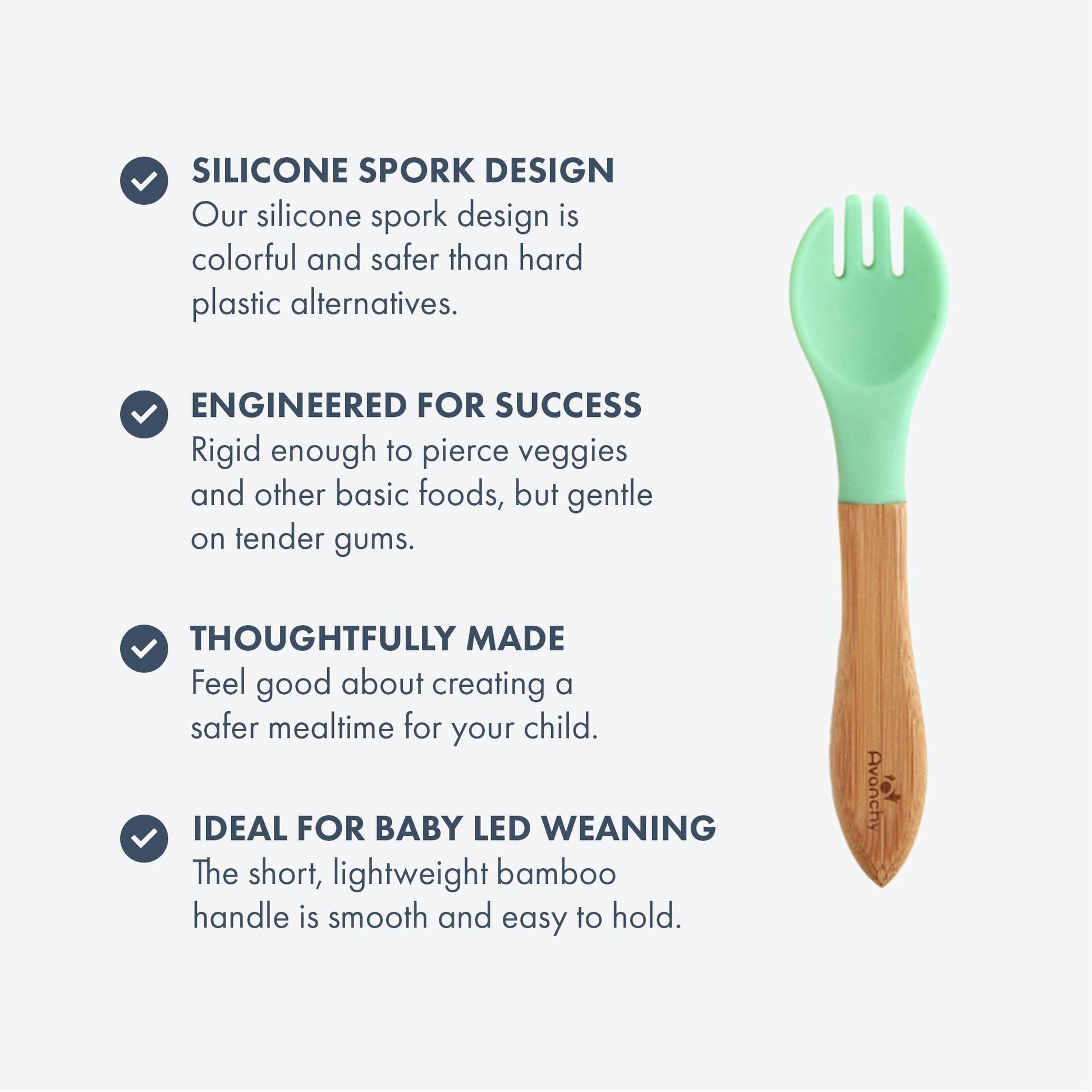 Toddler hands holding Avanchy bamboo training fork during mealtime