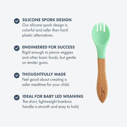 Toddler hands holding Avanchy bamboo training fork during mealtime