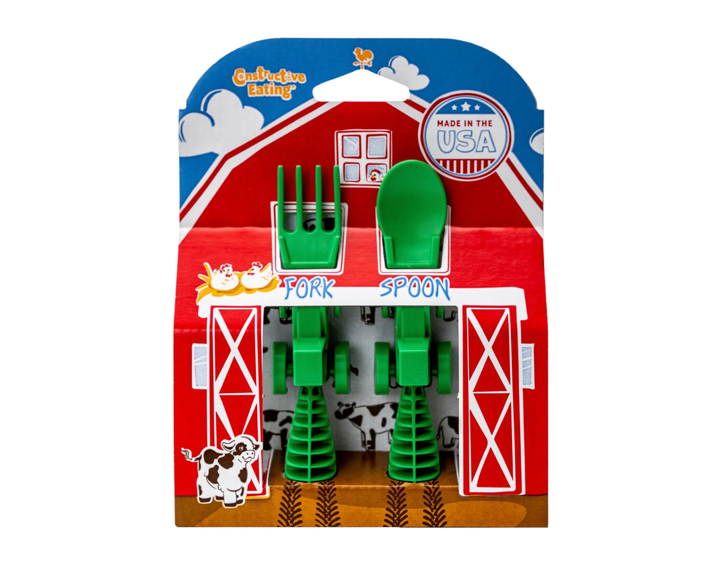Child using Constructive Eating tractor utensils at the table