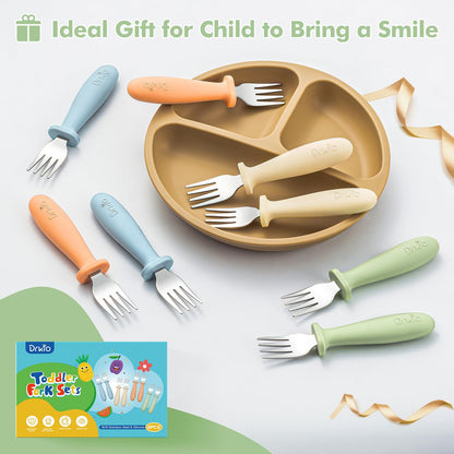 Toddler hands holding Drkio ergonomic silicone handle forks