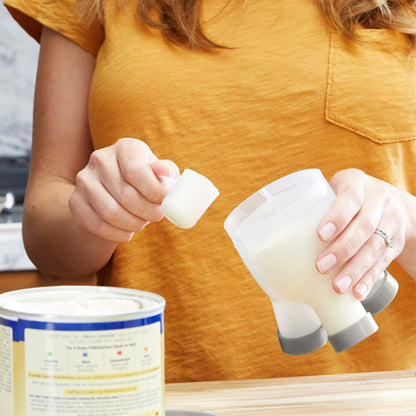 Boon tripod baby milk powder container fitting into a diaper travel bag.