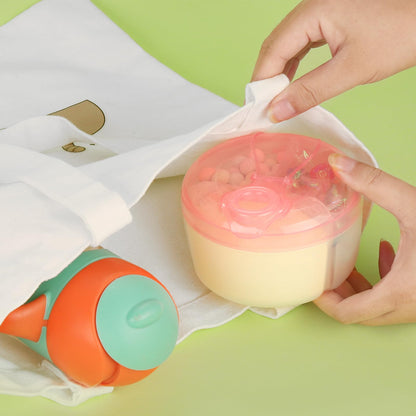 Accmor pink rotating formula container held by a parent outdoors.