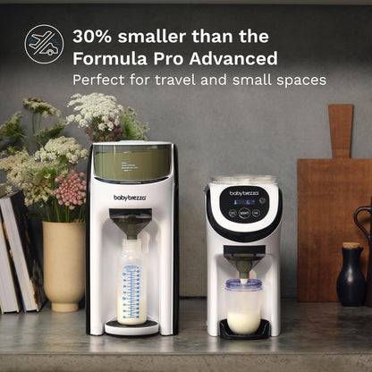 Baby Brezza compact portable formula dispenser machine on a kitchen countertop
