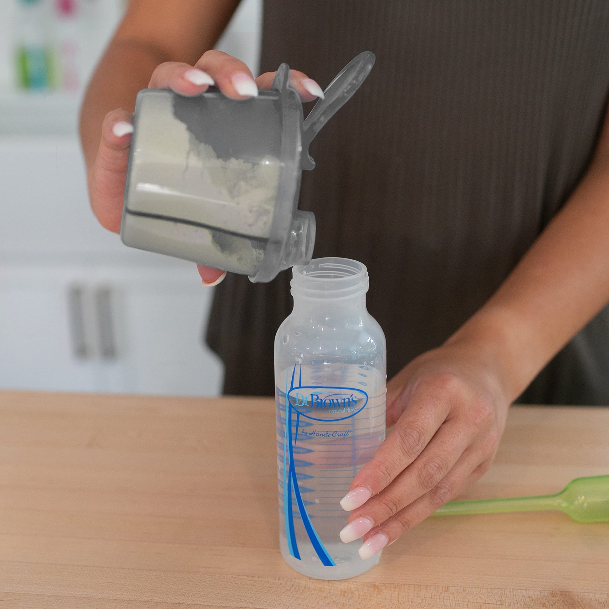 Close up of the easy pour spout on the Dr. Brown's gray baby formula container