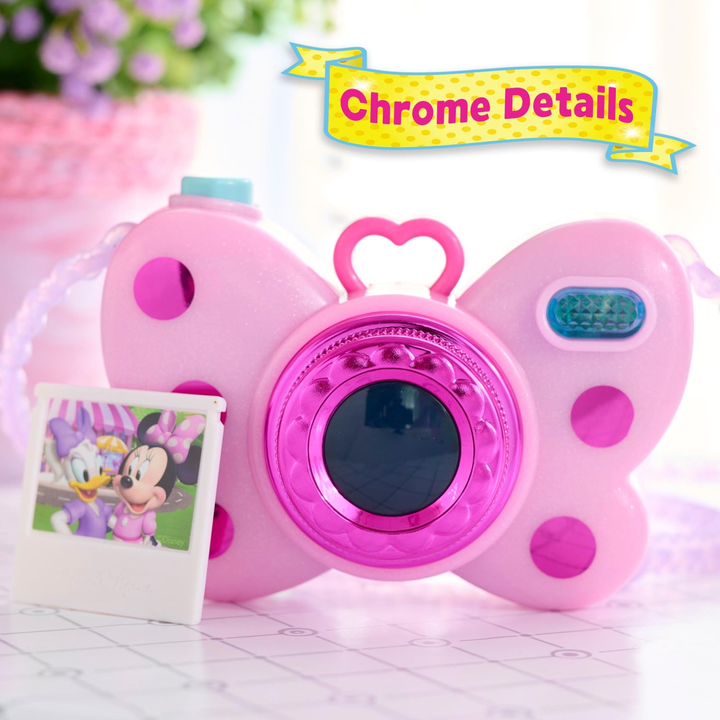 Side view of the pink Minnie Mouse electronic toy camera showcasing the battery compartment and durable plastic build.