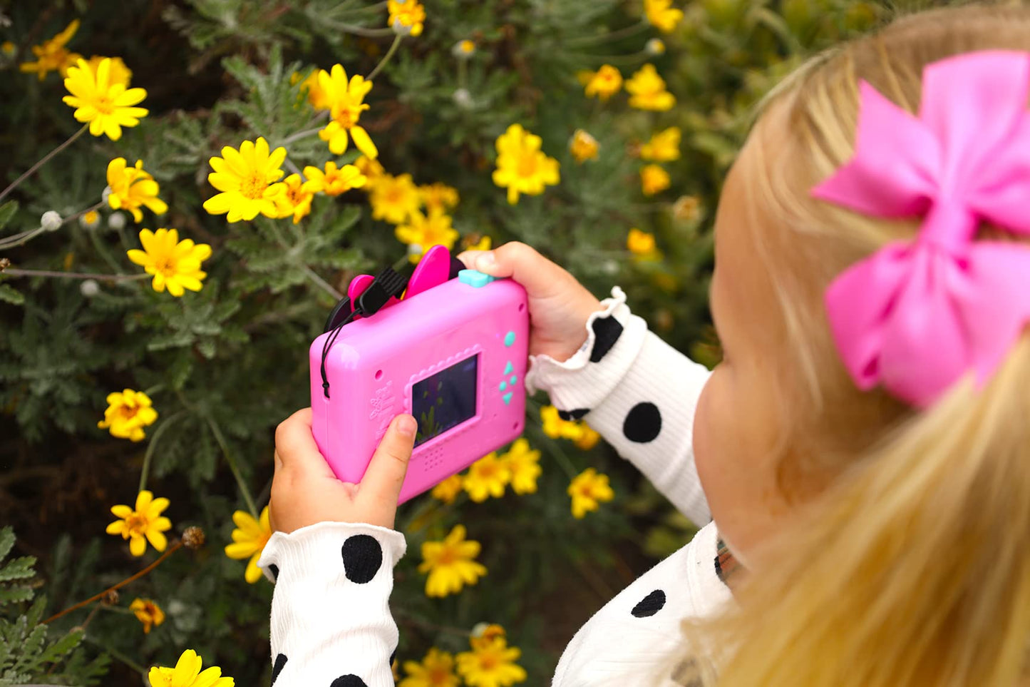 Back view of the pink eKids photography toy showing the battery compartment and compact grip size.