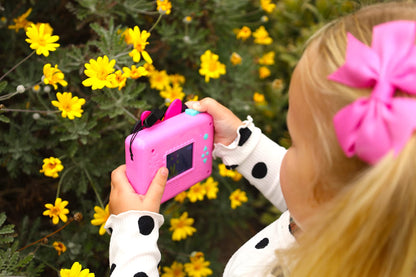 Back view of the pink eKids photography toy showing the battery compartment and compact grip size.