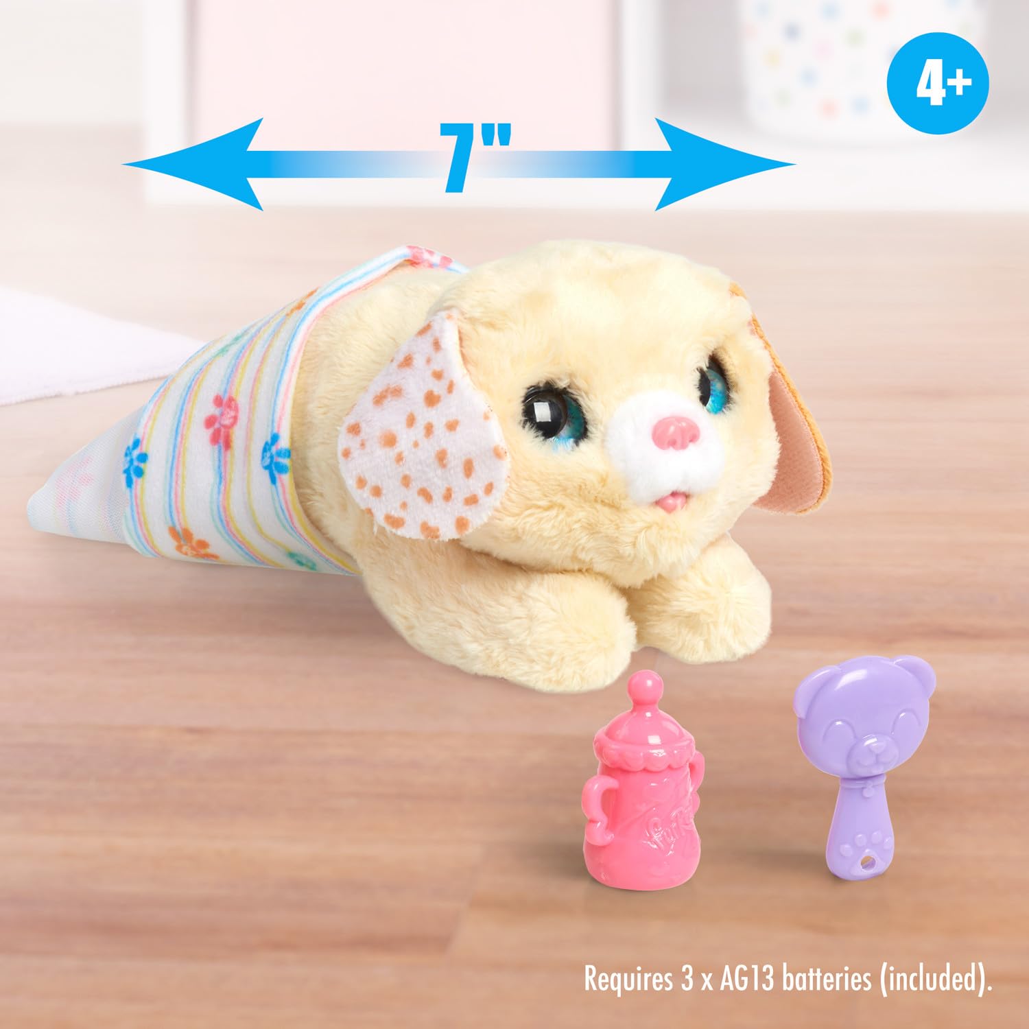 FurReal Newborns interactive dog toy being fed with the included miniature bottle accessory.