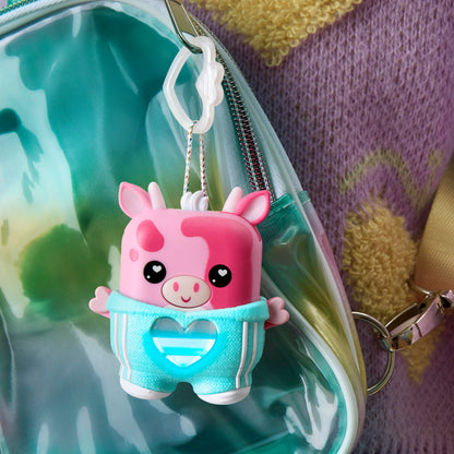 Pink electronic cow toy showcasing the color changing heart meter notification system