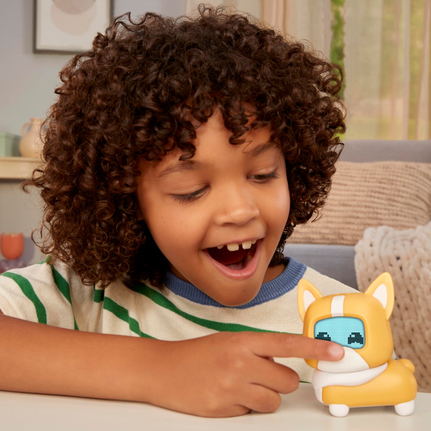 MGA Entertainment virtual puppy toy being patted on the head to trigger sensors.