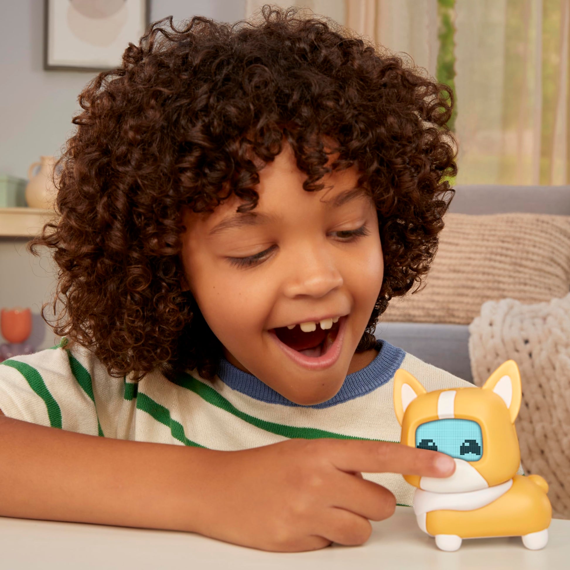 MGA Entertainment virtual puppy toy being patted on the head to trigger sensors.
