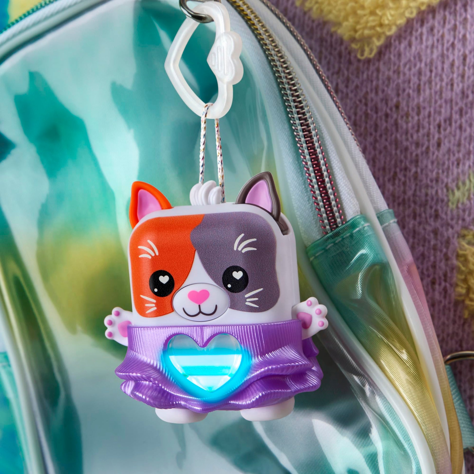 Side profile of the two point seven inch miniature electronic cat toy showcasing the durable plastic body.