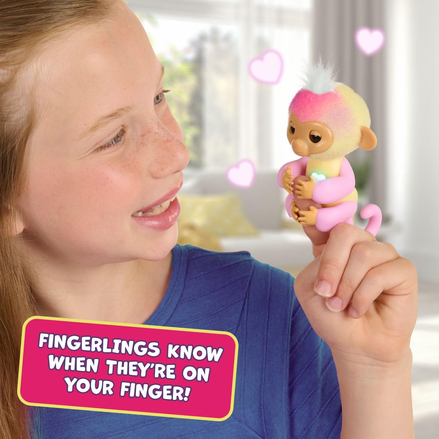 Fingerlings Alix axolotl companion toy sitting on a child hand showing dry play touch interaction
