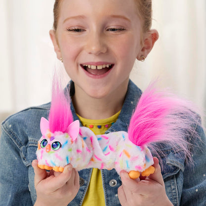 Close up of the forehead heart gem button on the pink and white Furby DJ Furblets electronic pet