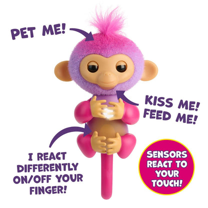 Fingerlings robotic monkey toy with posable tail sitting upright on a desk shelf