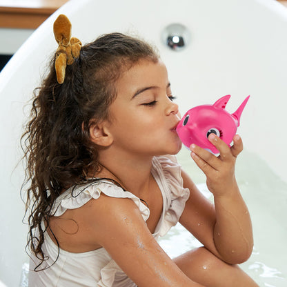 Toddler playing with the imported singing robotic shark toy during bath time