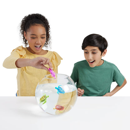 Children playing with the orange and blue Robo Alive turtles during bath time