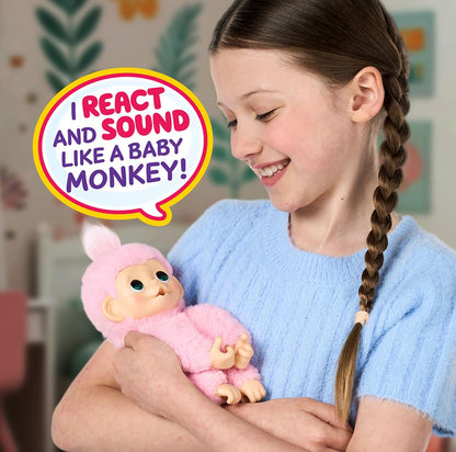 Little Live Pets mini interactive monkey hanging from a finger using its grippy hands.