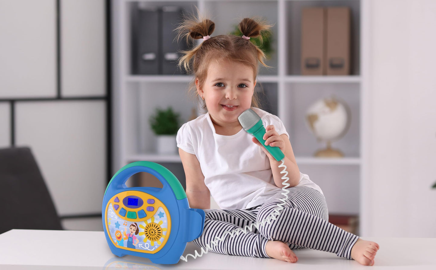 eKids Ms Rachel Bluetooth party speaker with the included real working wired microphone resting alongside
