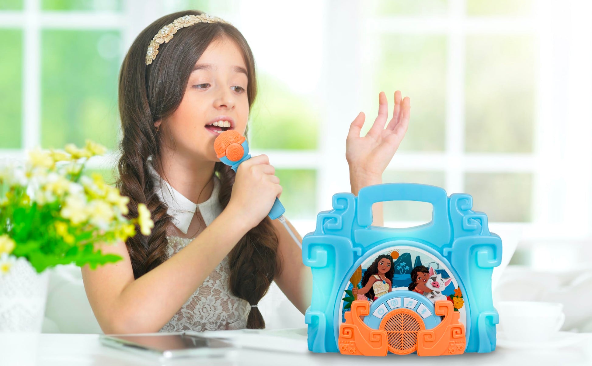 eKids Disney Moana portable boombox toy being carried by its built-in handle demonstrating lightweight design.